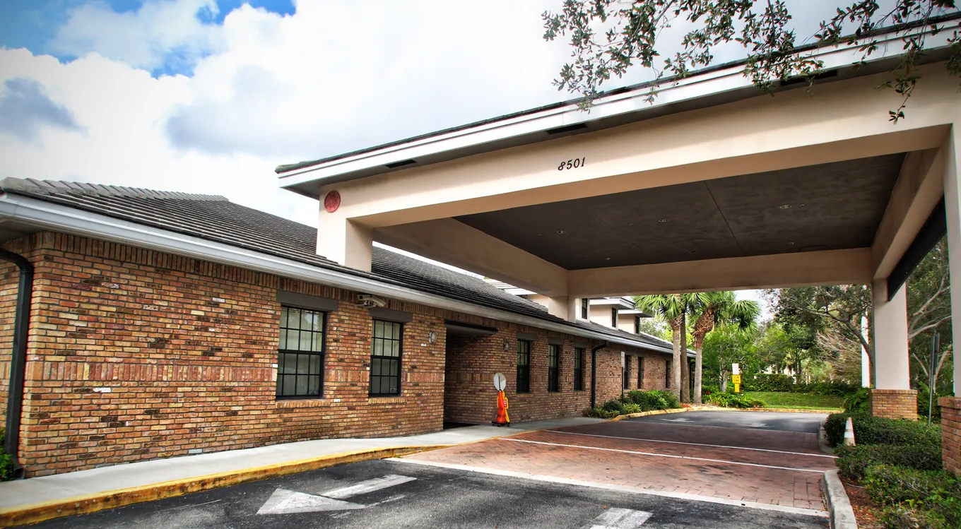 The front of the Andover Academy building with a covered drop-off entrance